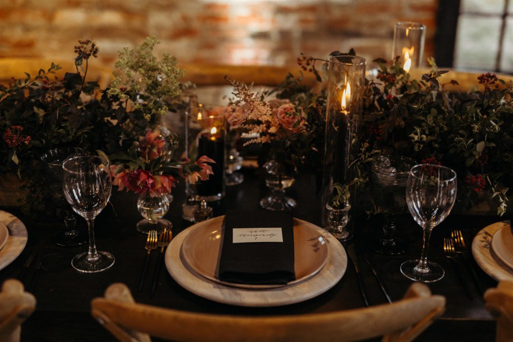 rustic industrial chic wedding mt washington mill dye house baltimore maryland the one moment events velvet wedding linen dark and moody wedding reception place setting flowers black candles 