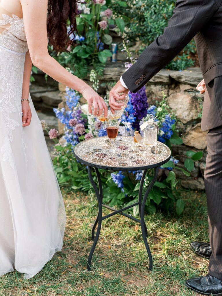a couple pours a cocktail for their wedding ceremony 
