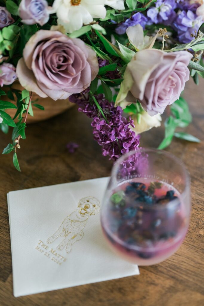 a glass with a drink with blueberries floating in it