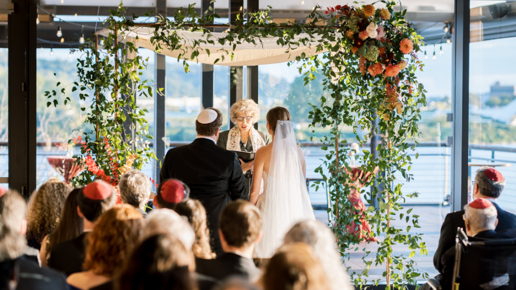 a fall wedding in DC by The One Moment Events.  A jewish wedding with a chuppah adorned with fall flowers 