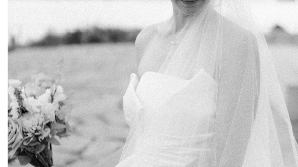 A black and white film photo of a bride 