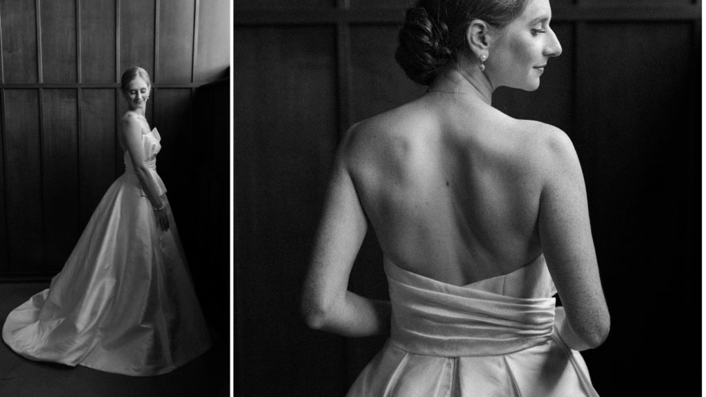 A bride stands poised gracefully in her wedding down in a black and white film style photo 