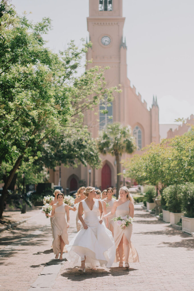 Indoor museum wedding ceremony in the historic Gibbes Rotunda. Elegant Charleston wedding inspiration with sage green velvet chairs and lush white floral arrangements.